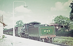 Steam train number 26 and passenger carriages at railway station platform, Arima, Trinidad early 1960s