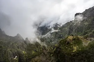 Steep cloudy mountain landscape with rock formations