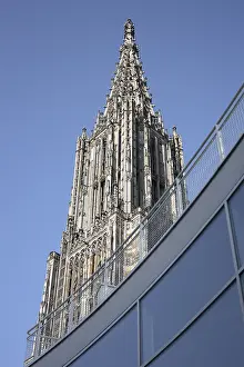 Steeple of Ulm Cathedral behind the glass facade of the Town Hall