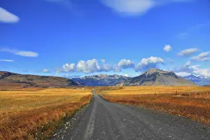 Steppes of Patagonia. Dirt road passes between the plains to the distant mountains