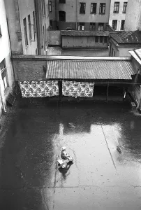 Stockholm in the 1950s. A child rides a tricycle in a backyard in central Stockholm