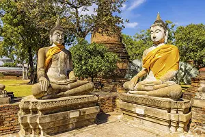 Stone Buddha statues decorated with yellow cloths