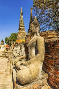 Stone Buddha statues sitting in a row