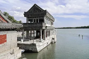 Framed Print : Stone building on water with traditional architecture under blue sky Framed Print : Stone building on water with traditional architecture under blue sky