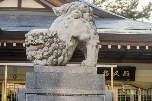Stone carved lion in front of Shinto Temple building in Hiroshima