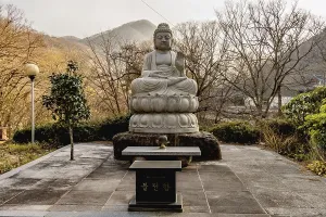 Stone carved sitting Buddha at Buddhist temple