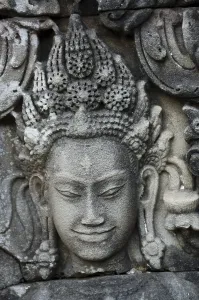 Stone carving of a female face