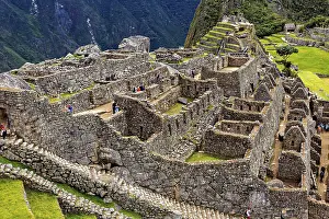 Stone Inca ruins of Machu Picchu surrounded by mountainous landscape