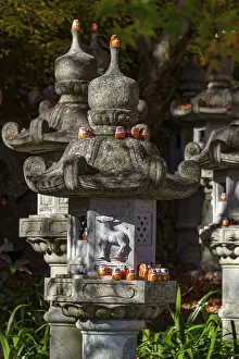 Stone lanterns with small figures in a Japanese garden