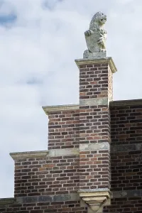 Stone lion on medieval gable and house roof in the netherlands