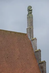 Stone lion on medieval gable and house roof in the netherlands