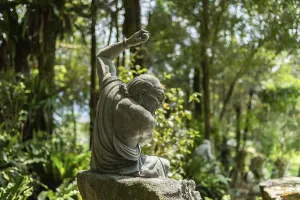 Stone ruined Arhat statue in forest, Taiwan, Asia