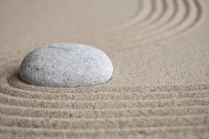 Stone on sand with customizable space for text or message