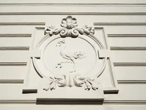 Stone sculpture, bird ostrich with horseshoe in beak