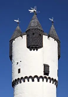 Keep with stone spire and smaller turrets on the battlements against a blue sky