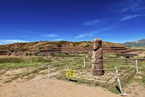 Stone statue in a ruined landscape with a prohibition sign in the foreground