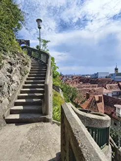 Stone steps lead to a vantage point with a view of the city of Graz Styria Austria