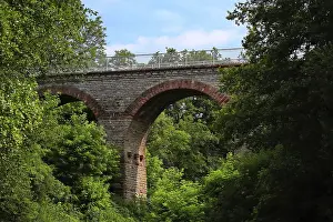 Framed Print : Stone viaduct hidden between densely wooded trees near Eichelberg