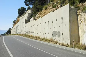 Stone wall as protection against rockfall at a coastal street