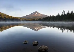 Three stones in the water, reflection of the volcano Mt