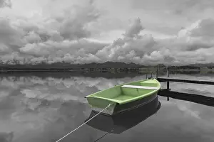 Category Mountain Landscapes Prints: Storm clouds at sunset, a green rowing boat lashed to the wooden jetty