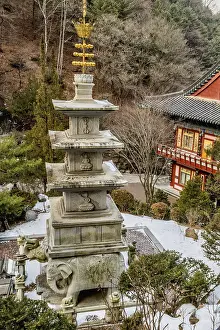 Four story stone carved pagoda on plinth of three elephants at Buddhist temple in South Korea