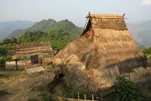 Straw roofed bamboo huts of the ethnic Akha people in a traditional mountain village