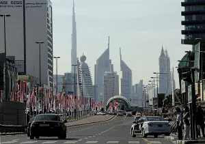 Street with car traffic, flagpoles