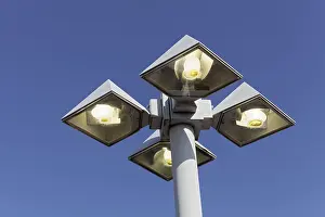 Street lamp burning in daylight