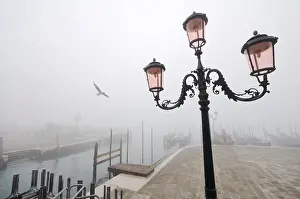 Street lamp and gondolas in the fog