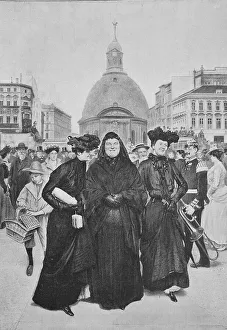 Street scene in Berlin with three woman and many passers-by