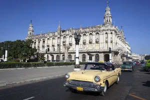 Street scenery, Oldtimer driving in front of Gran Teatro de La Habana Alicia Alonso