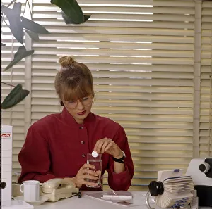 Stress in the office, secretary takes effervescent tablet Office scene