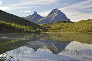 Striking mountains reflected in the calm waters of a small lake
