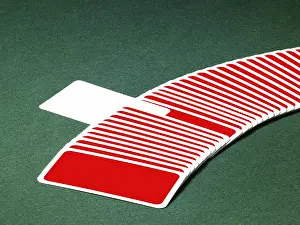 Studio photography of spread out playing cards in a row with one chosen