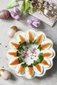 Stuffed eggs with cheese and salted salmon in the form of a carrot