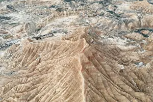 A stunning aerial view captures the intricate patterns of an arid mountain landscape Natural striations
