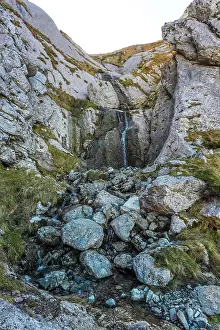 Stunning waterfall cascades down rugged rocks in mount txindoki