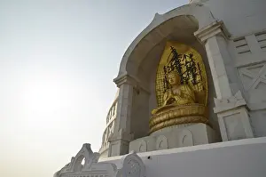 Stupa, sculpture of a golden seated Buddha