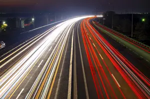 Suburban highway at night. Traces from headlights and taillights of heavy traffic