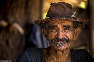 Faces Of The World Prints: Sugar cane farmer wearing a hat