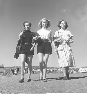 Summer of 1951. Three young women are walking towards the photographer