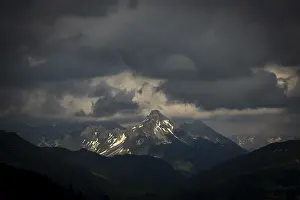 Summit of the Biberkopf with remnants of snow and dramatic clouds