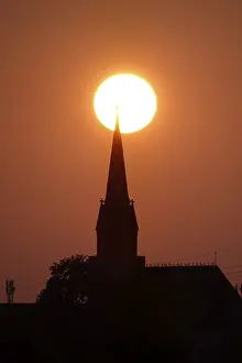 Sun in the evening in June, church tower, Germany