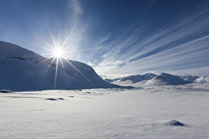 Category Scandinavia Prints: Sun over mountain range in the snow