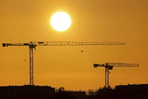 The sun rises in the morning behind the Frankfurt district of Riedberg