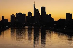 The sun sets behind the Frankfurt banking skyline