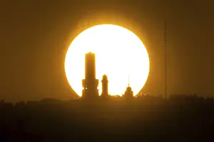The sun sets behind the towers on the summit of the GroBer Feldberg in the Taunus