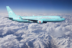 SunExpress Boeing 737 in flight over mountains