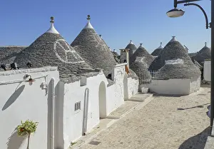 Sunny impression of trulli houses at a town named Alberobello in Apulia